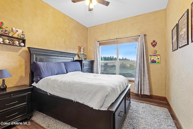 bedroom featuring ceiling fan and dark hardwood / wood-style floors