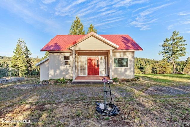 bungalow-style home with a front yard