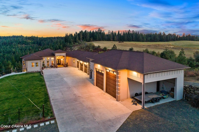 view of front of home featuring a garage and a yard