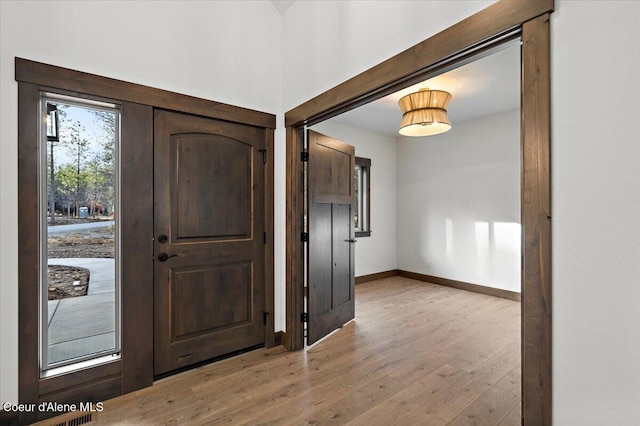 foyer entrance with light hardwood / wood-style floors