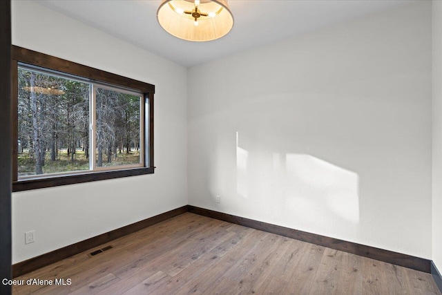 spare room with wood-type flooring