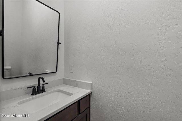 bathroom with toilet and vanity