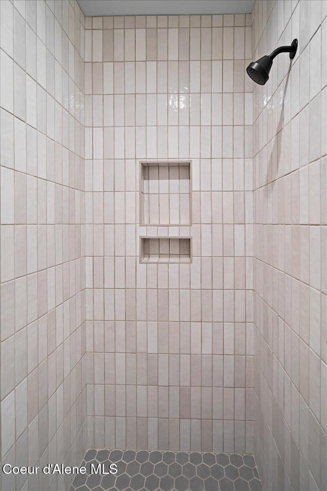 bathroom with a tile shower