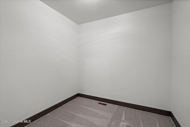 unfurnished room featuring carpet flooring