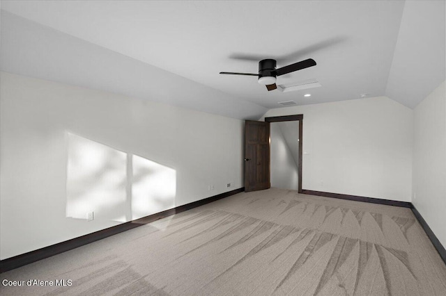 carpeted empty room with lofted ceiling and ceiling fan