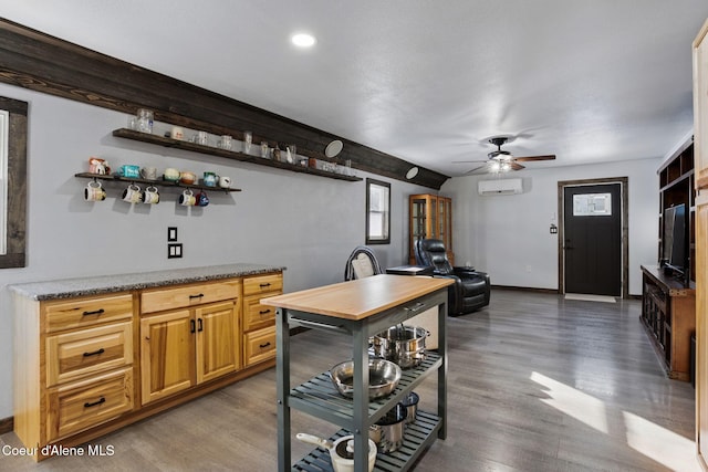 bar featuring ceiling fan, dark hardwood / wood-style floors, and a wall mounted air conditioner