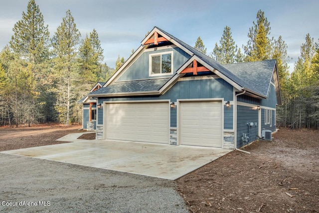 exterior space with cooling unit and a garage