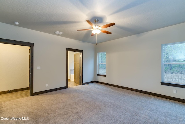 empty room with light carpet and ceiling fan