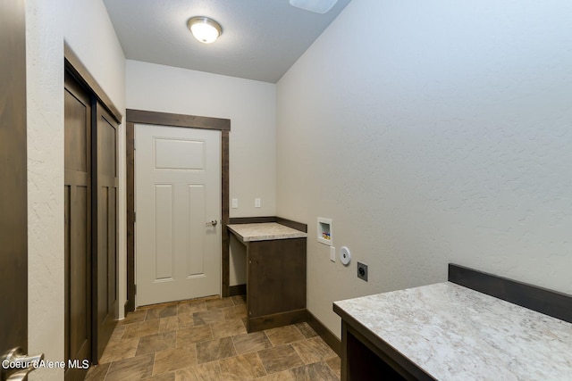 washroom with washer hookup, hookup for an electric dryer, and cabinets