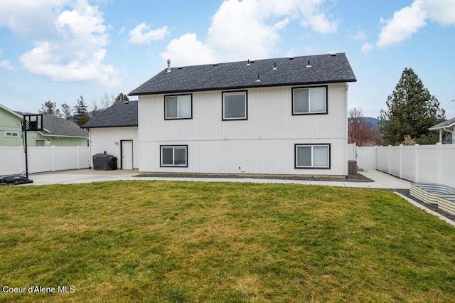 rear view of house featuring a yard and a patio area