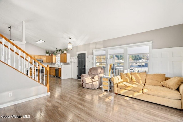 living room with lofted ceiling and light hardwood / wood-style floors