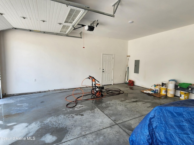 garage featuring a garage door opener and electric panel