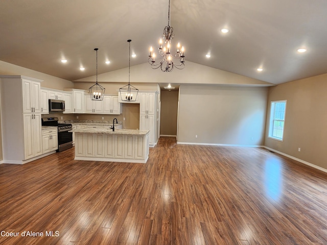 kitchen with white cabinets, pendant lighting, appliances with stainless steel finishes, and an island with sink