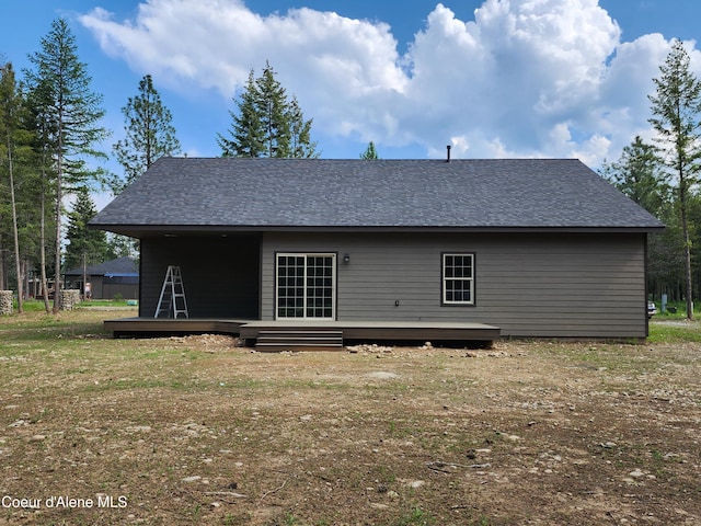 rear view of house featuring a yard