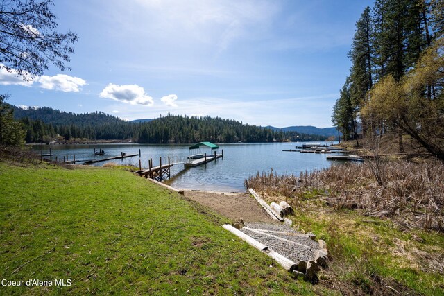 19503 E Hayden Lake Rd, Hayden, ID 83835 - dock area with a lawn, a water view, and a view of trees