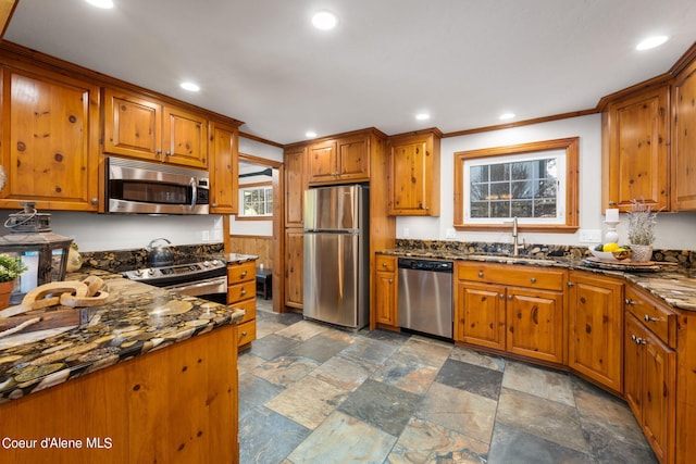 19503 E Hayden Lake Rd, Hayden, ID 83835 - kitchen featuring brown cabinets, ornamental molding, a sink, and stainless steel appliances