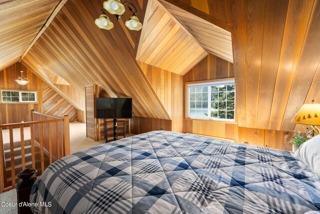 19503 E Hayden Lake Rd, Hayden, ID 83835 - bedroom with carpet, wood walls, and lofted ceiling