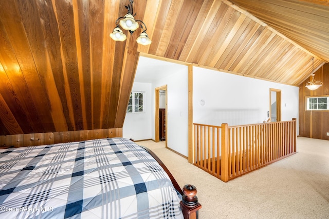19503 E Hayden Lake Rd, Hayden, ID 83835 - carpeted bedroom with lofted ceiling, multiple windows, and wood ceiling