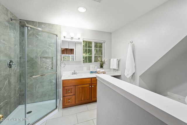 19503 E Hayden Lake Rd, Hayden, ID 83835 - full bath with tile patterned flooring, vanity, and a stall shower