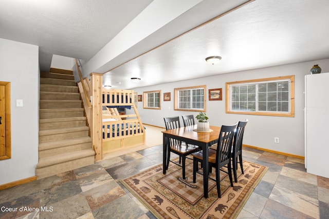 19503 E Hayden Lake Rd, Hayden, ID 83835 - dining room with baseboards, a textured ceiling, stairway, and stone finish flooring