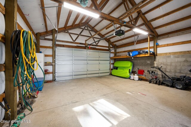 19503 E Hayden Lake Rd, Hayden, ID 83835 - garage featuring concrete block wall and a garage door opener