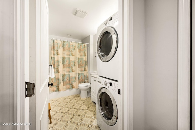 laundry room featuring stacked washer and dryer