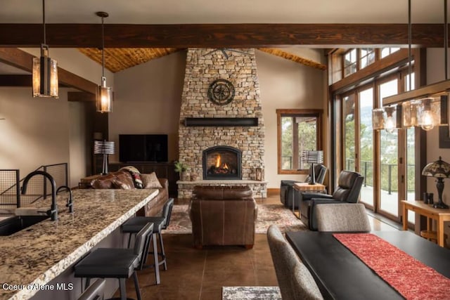 tiled living room featuring high vaulted ceiling, sink, beam ceiling, and a fireplace