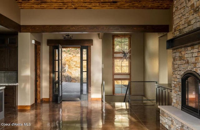 entryway featuring brick ceiling and a stone fireplace