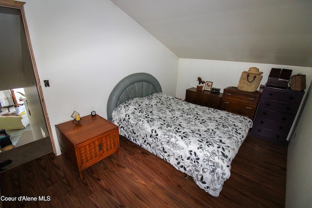 bedroom featuring dark hardwood / wood-style flooring and lofted ceiling