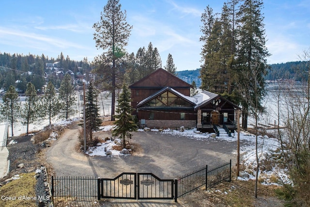 exterior space with a fenced front yard, a gate, a porch, and driveway