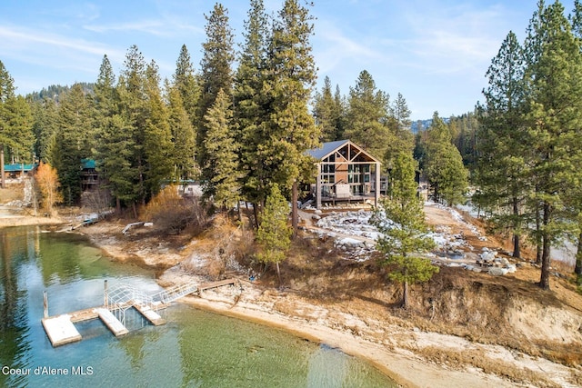 birds eye view of property with a water view and a view of trees