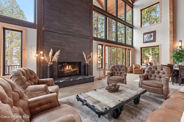 living area featuring a high ceiling and a fireplace