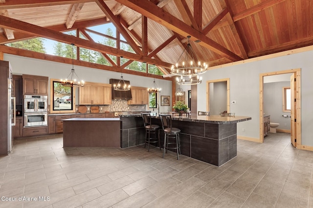 kitchen featuring hanging light fixtures, a large island, and a notable chandelier