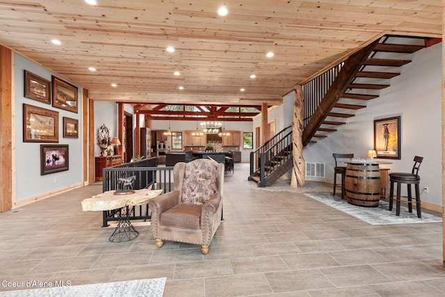 living room with wood ceiling, visible vents, stairway, and recessed lighting