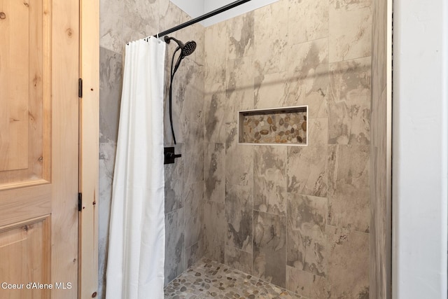 full bathroom with tiled shower