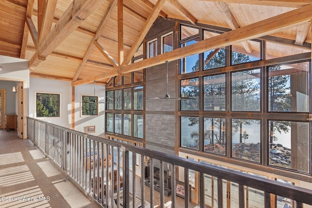 corridor featuring wooden ceiling and high vaulted ceiling