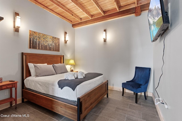 bedroom featuring beamed ceiling, wooden ceiling, and baseboards