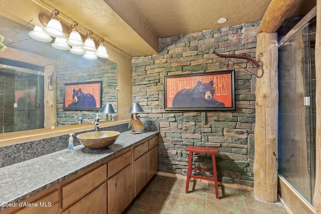 bathroom featuring a textured ceiling and vanity