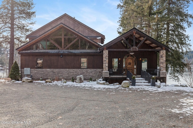 view of front of property with stone siding and covered porch