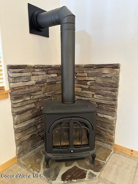 details featuring carpet and a wood stove