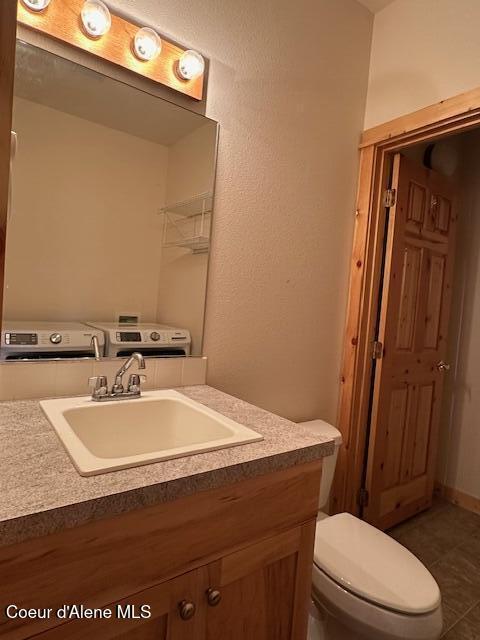 bathroom with toilet, tile patterned floors, and vanity