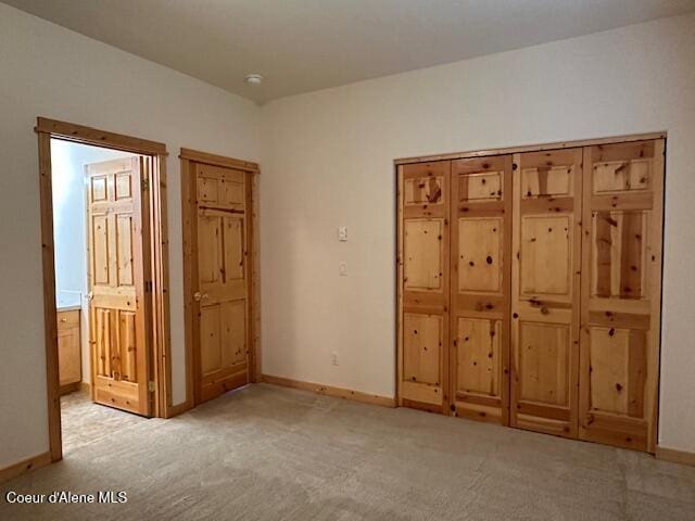 unfurnished bedroom featuring light colored carpet