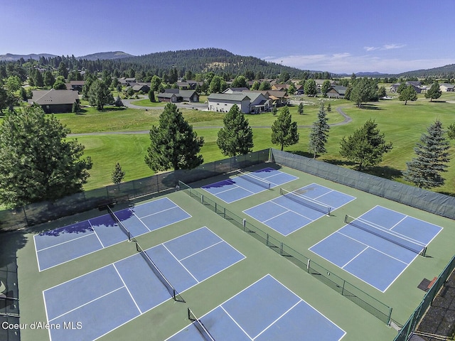 view of tennis court featuring a mountain view