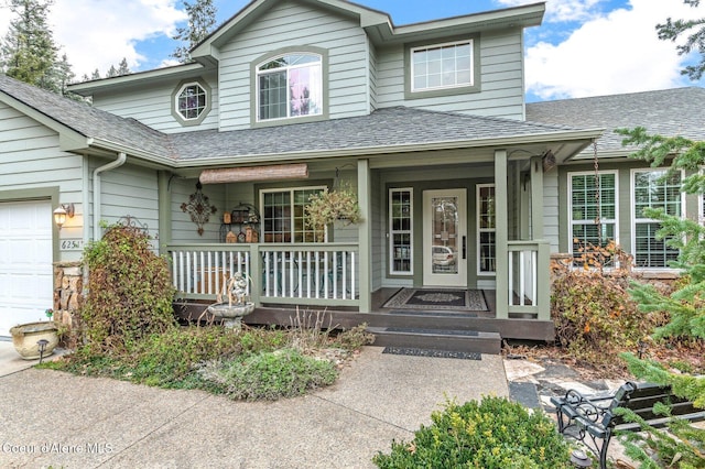 entrance to property featuring a garage and a porch