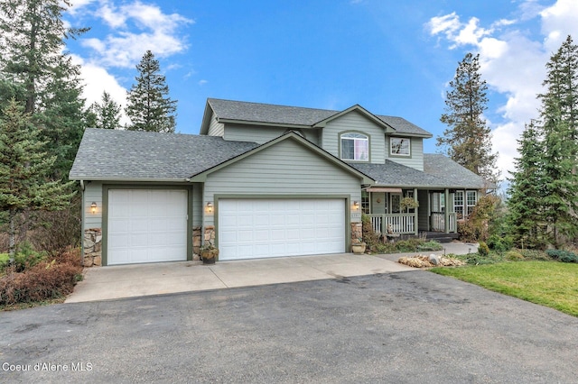 view of property featuring a garage and covered porch