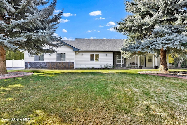 rear view of property with a yard