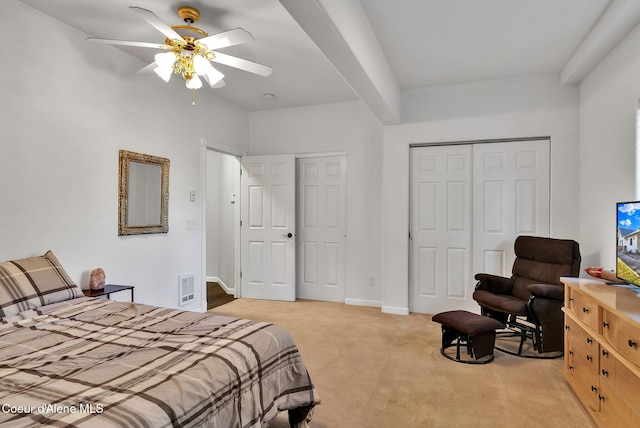 bedroom with light colored carpet, ceiling fan, and a closet