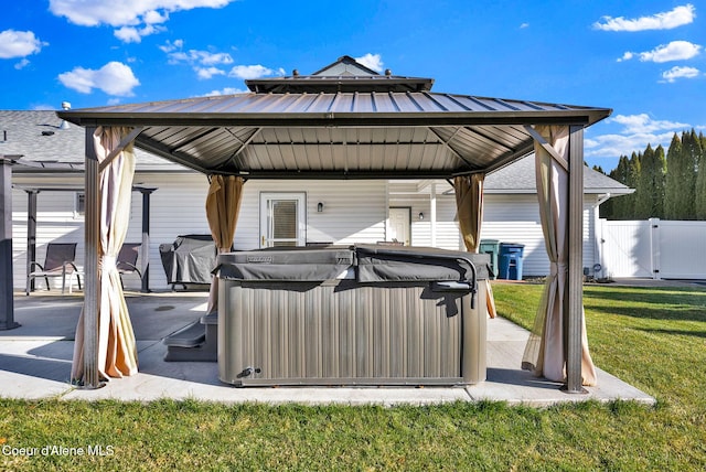 view of patio featuring a hot tub, a gazebo, and a grill