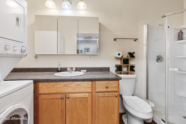 full bathroom with a stall shower, stacked washing maching and dryer, vanity, toilet, and a textured wall