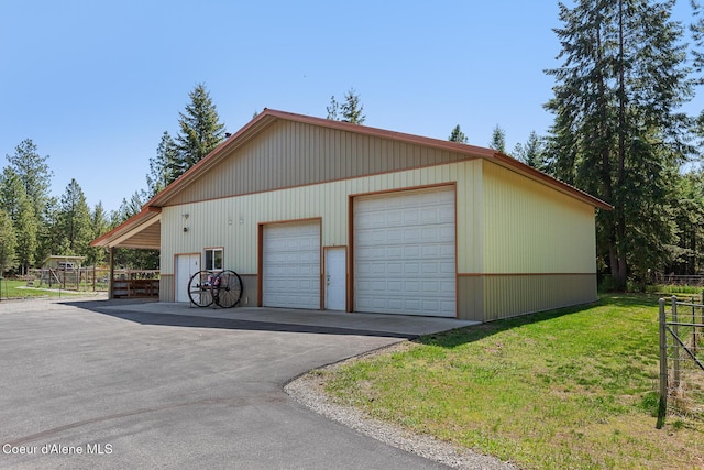 garage with fence and a detached garage